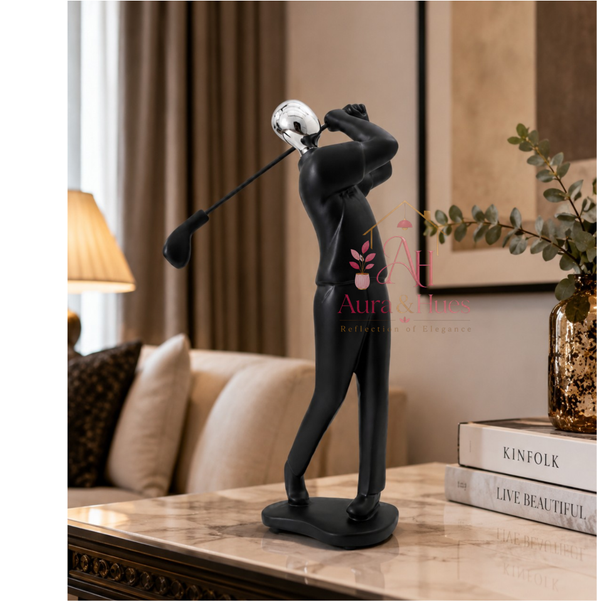 Black resin golfer figurine sculpture with silver head, displayed on a marble console table