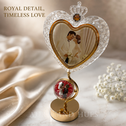 Crystal heart photo frame with crown and decorative globe base on white background