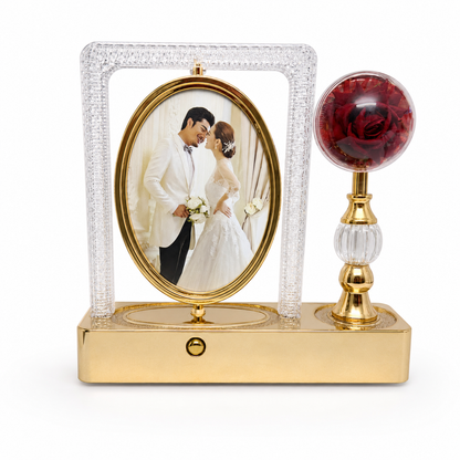 AS-50 gold crystal photo frame with rotating oval frame and red rose globe on white background
