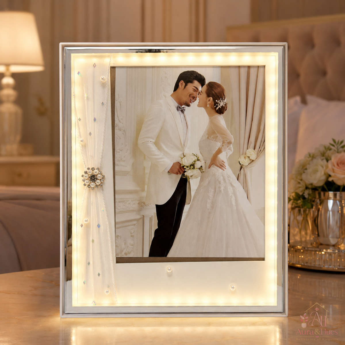 Warmly lit silver portrait frame with sheer fabric drape and LED border